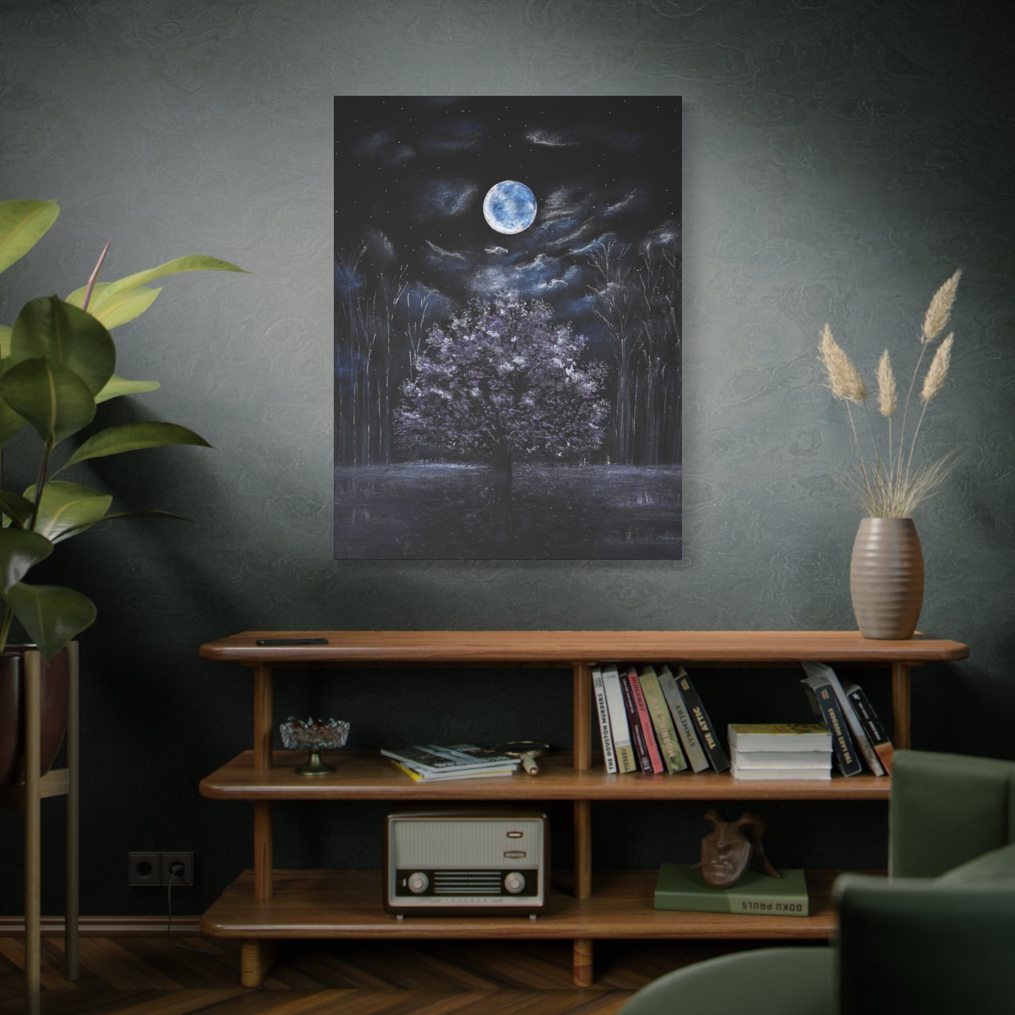 Bedroom interior with a Canvas Matte of a moonlit forest with a tree in the center, hanging on the wall above a wooden shelf and art decor.