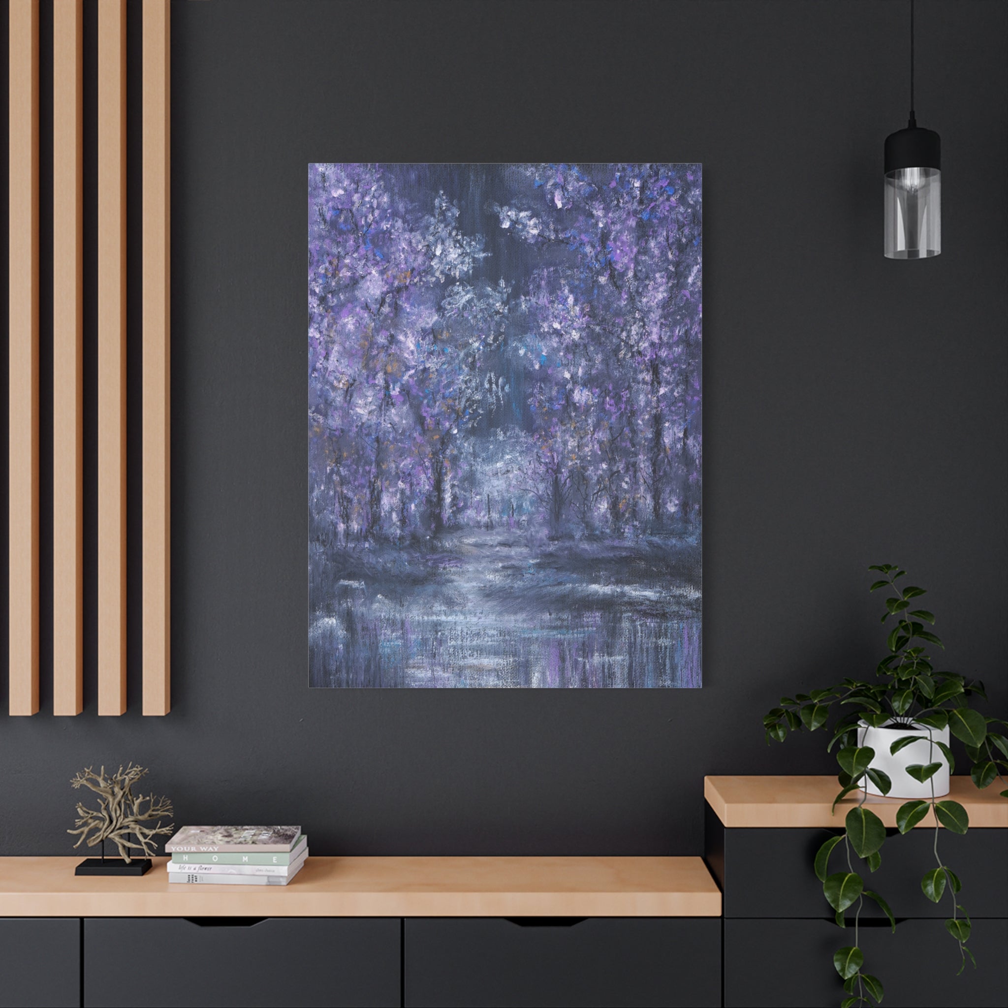 Canvas Art print of a forest scene in blue and purple tones hanging on a dark wall with wooden shelves and decor.