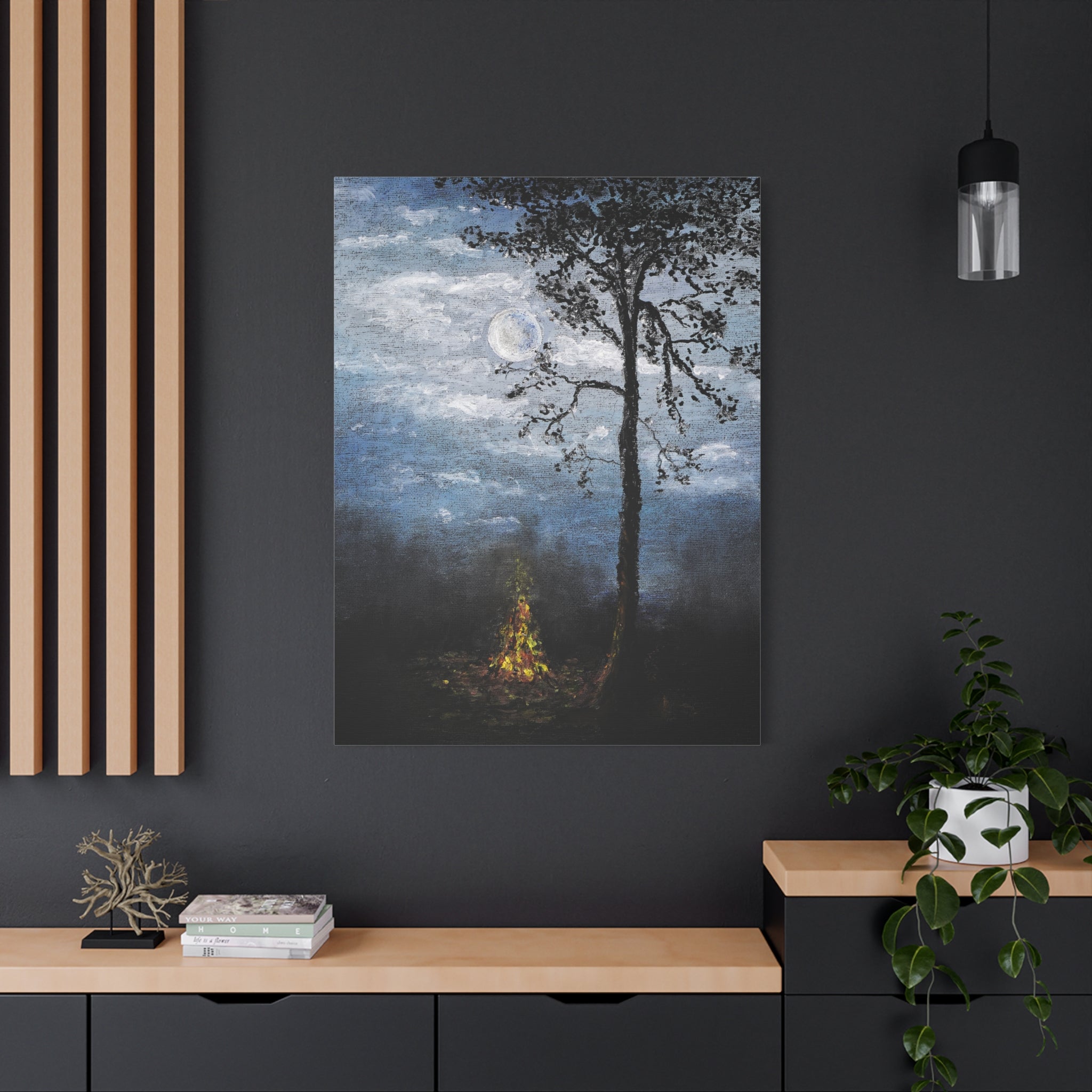 Canvas Art printed after original painting in oil colors of a tree and campfire against a dark wall with wooden shelves and decor. 