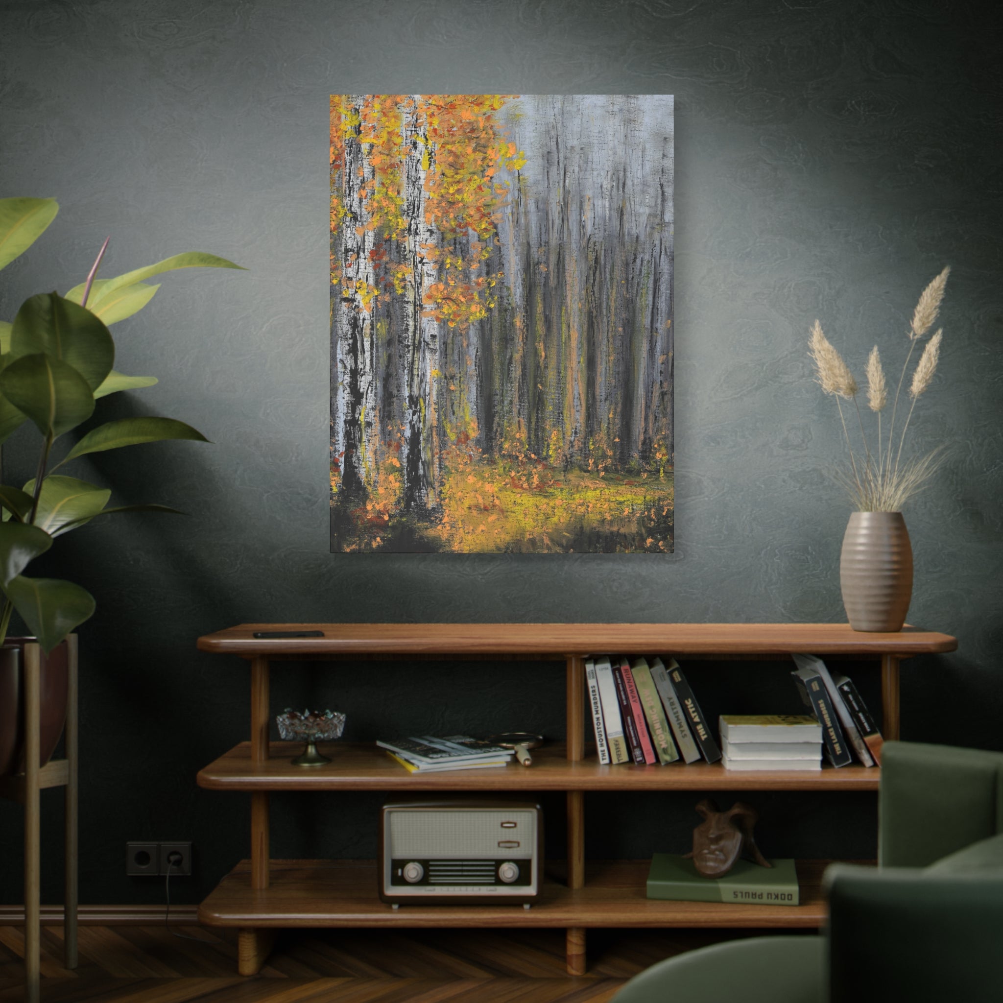 Living room with a wooden shelf, books, a plant, and a printed Matte Canvas of autumn trees in grey, yellow and green tones.