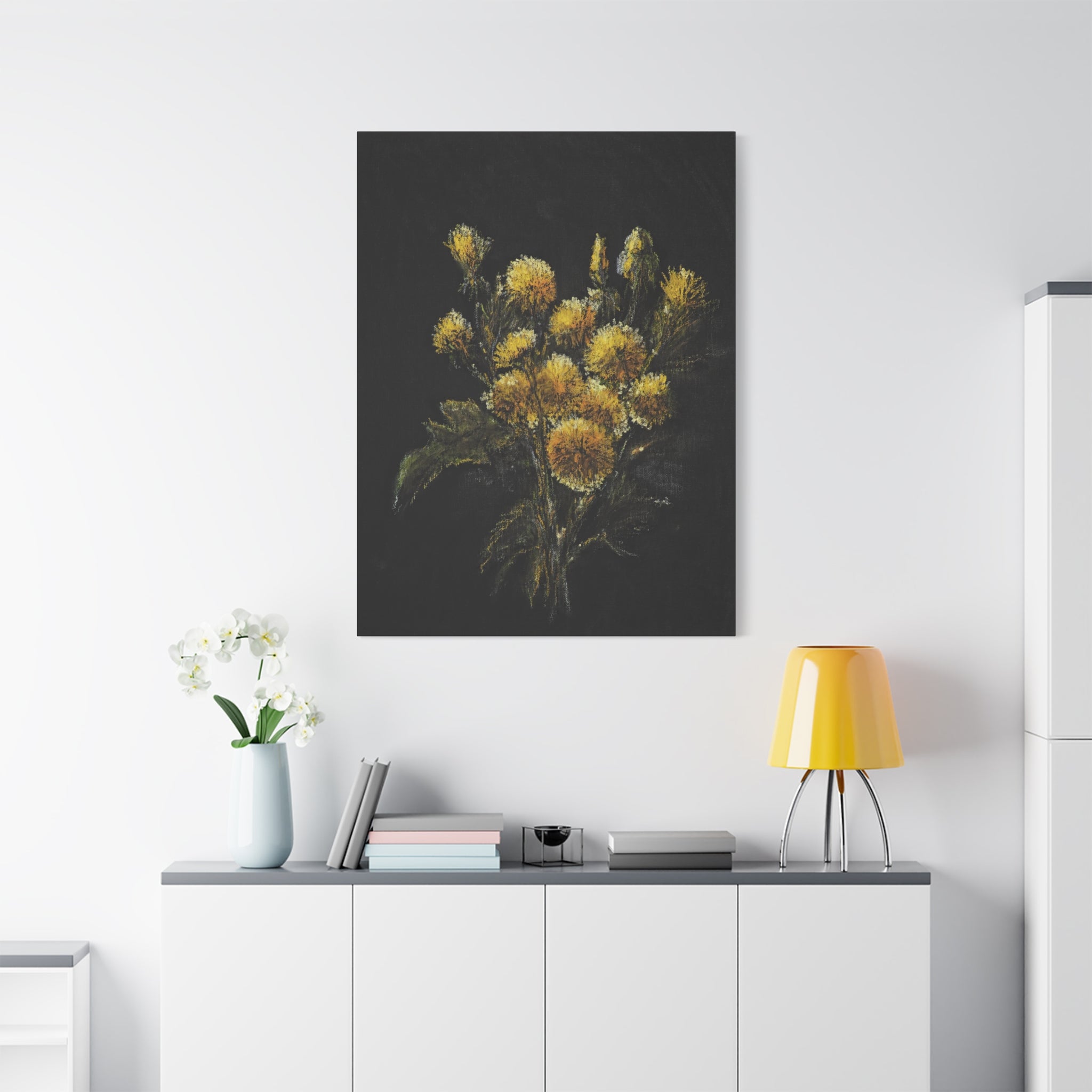 Floral printed matte canvas after an original artwork in oil colors in yellow and green tones on a wall above a white cabinet with decorative items.