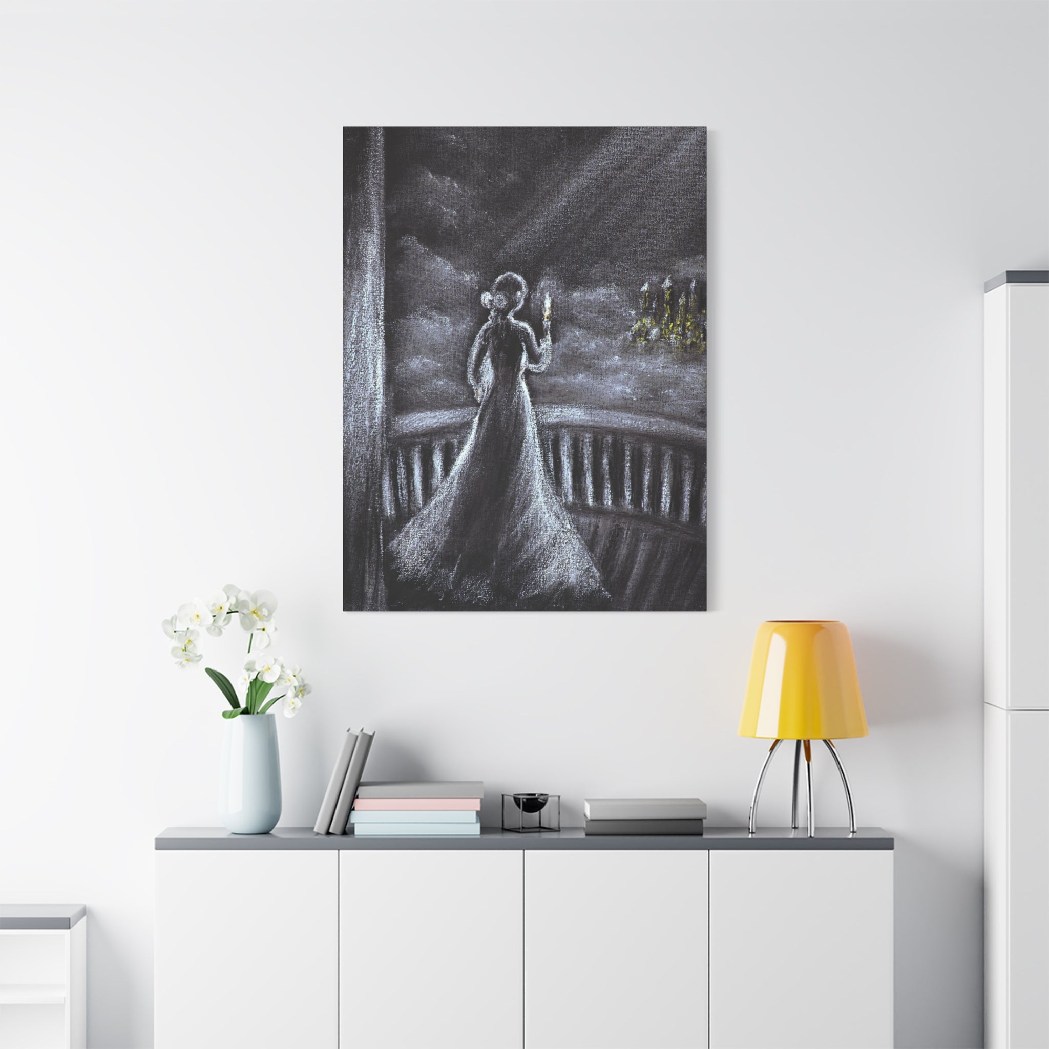  Gothic Woman with Candle Stretched Canvas Art-artistic depiction of a woman in a white dress with a lighted candle in a balcony, hanging on a white wall above a cabinet with decorative items.