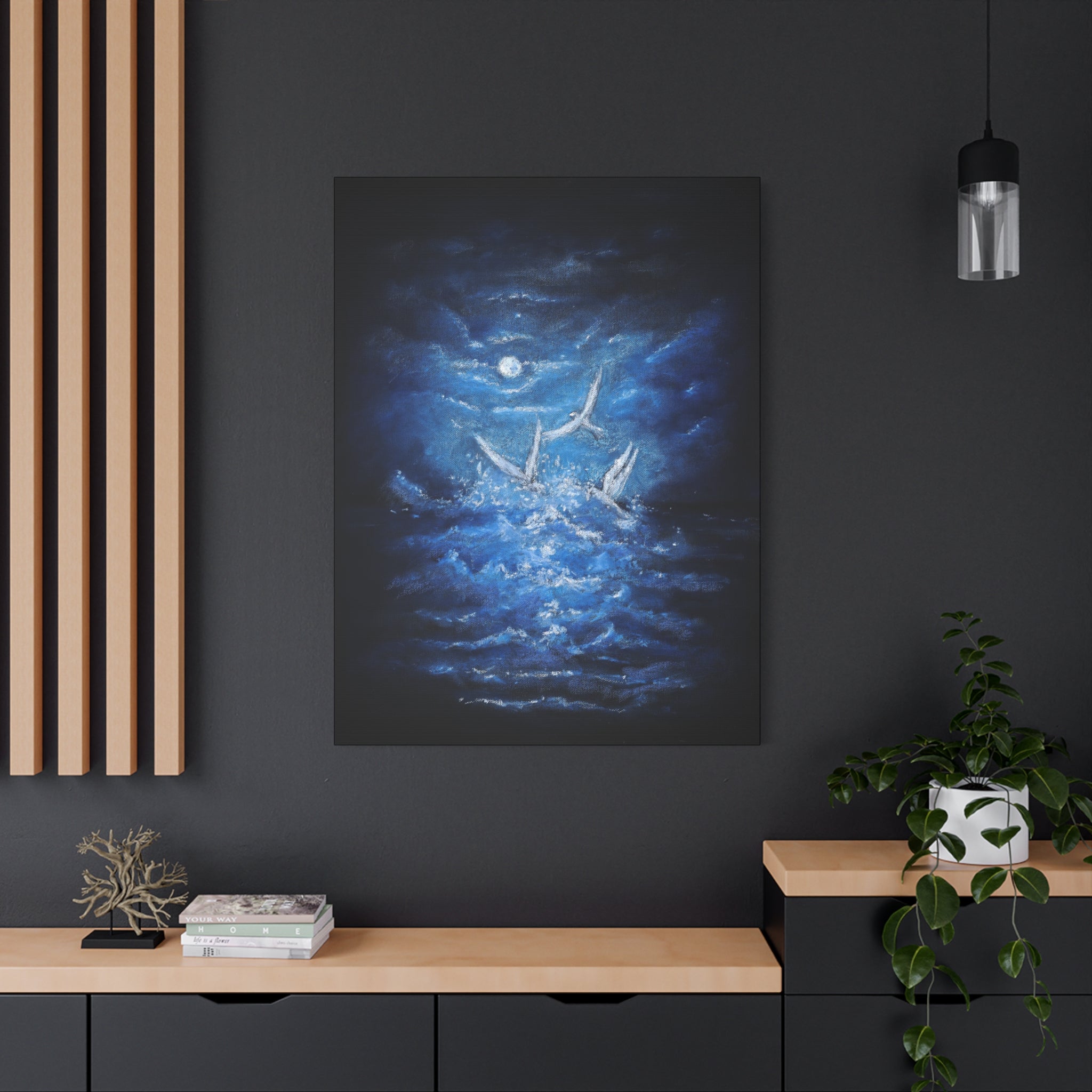 Printed Canvas artwork of a moonlit scene with a blue ocean and white birds on a dark wall above a wooden console table.