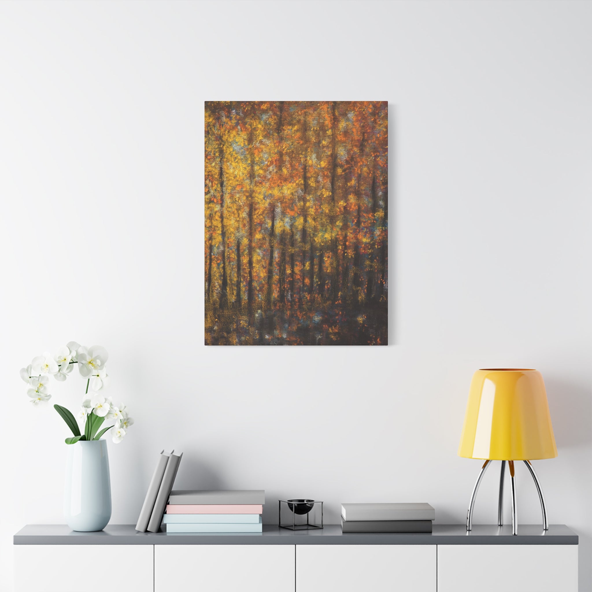 Autumn Forest Matte Canvas Wall Art of a forest scene with orange and yellow trees on a white wall above a shelf with decor items.