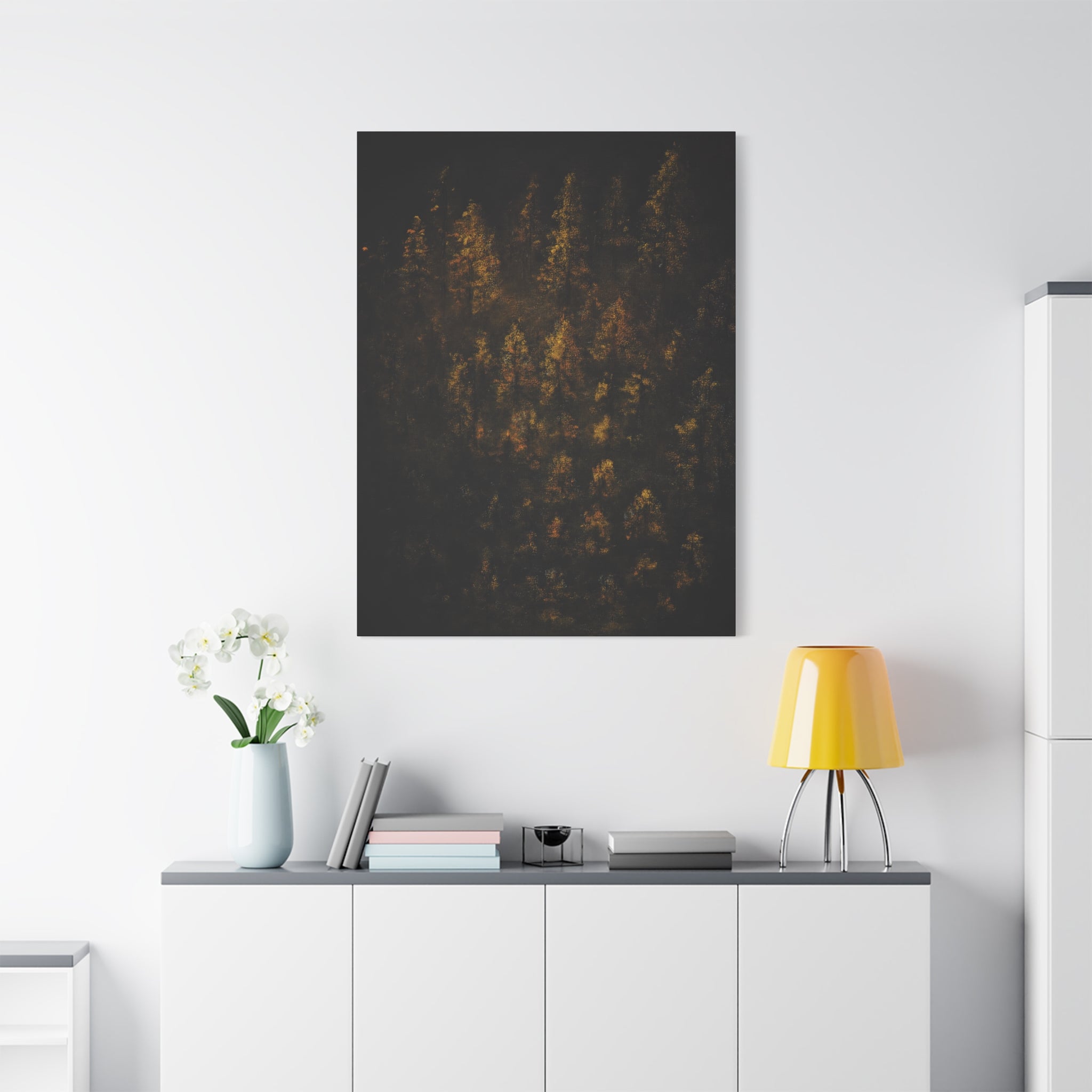 Modern interior with Autumn Forest Matte Canvas Print — Gold Fall Trees Wall Art, stretched 1.25", lamp, and decor items on a white wall.